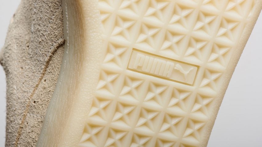 Фотография крупным планом резиновой подошвы бежевого цвета биоразлагаемых кроссовок Puma Re-Suede с протектором и логотипом Puma.