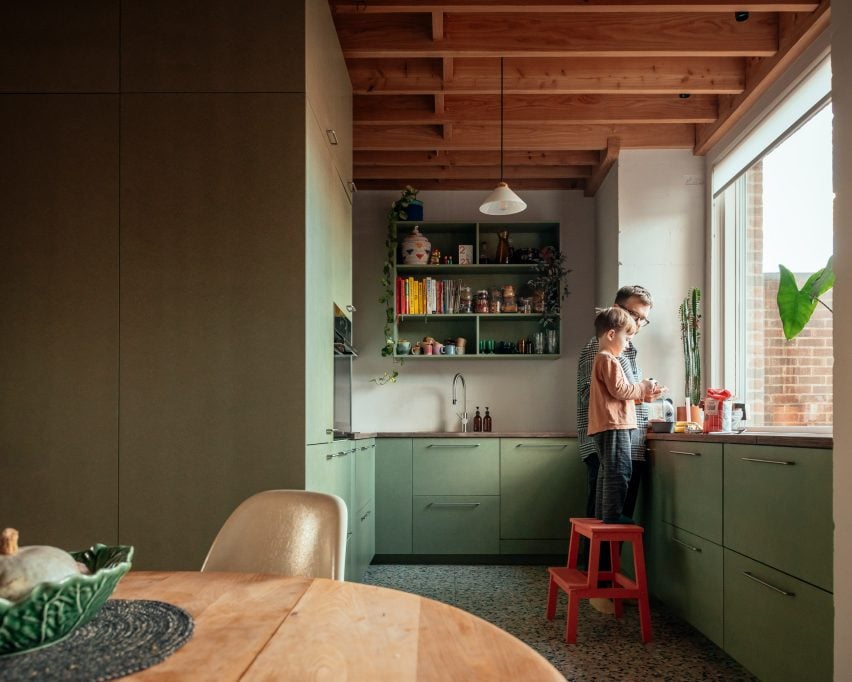 Кухня с зеленой мебелью и деревянной крышей